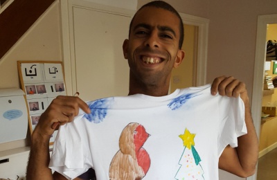 Diagrama Foundation: A Cabrini House resident shows off his T-shirt artwork