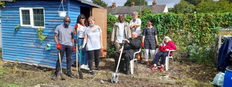 People supported at Bromley Supported Living and Diagrama staff together at the allotment